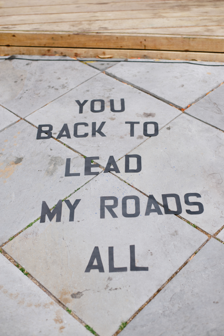 sidewalk art that reads "alll my roads lead back to you"
