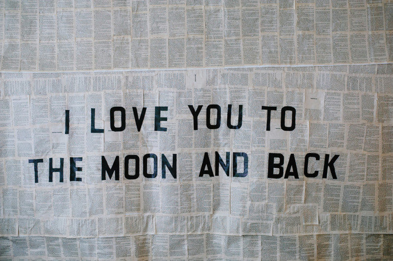 Art on pages of text that reads "I love you to the moon and back"