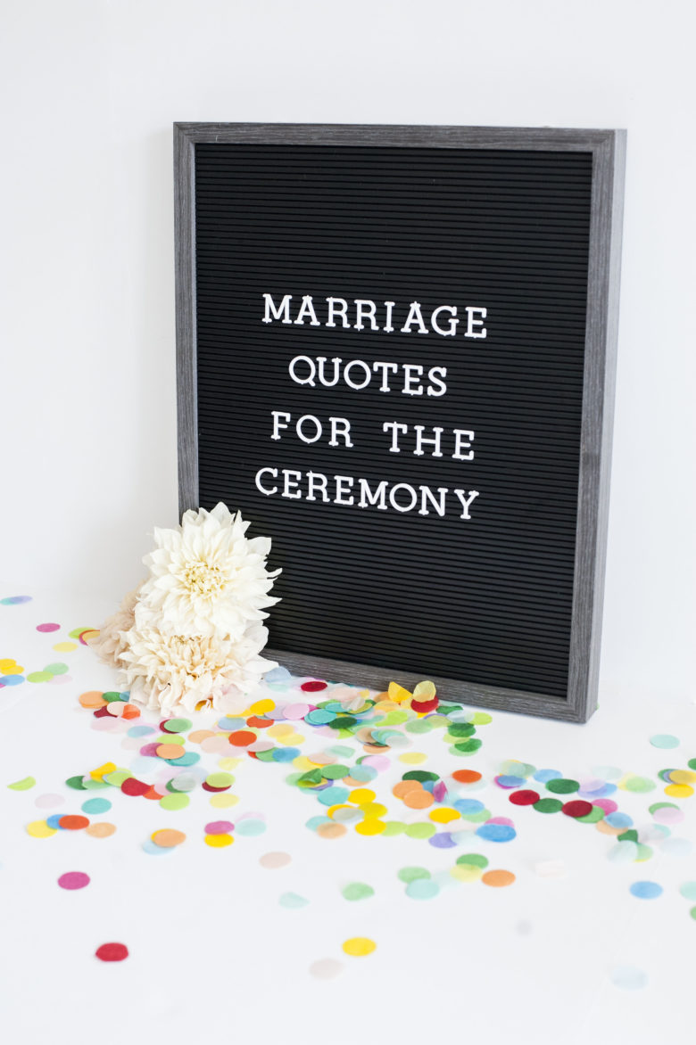 Black board on confetti that says "marriage quotes for the ceremony" with confetti and flowers