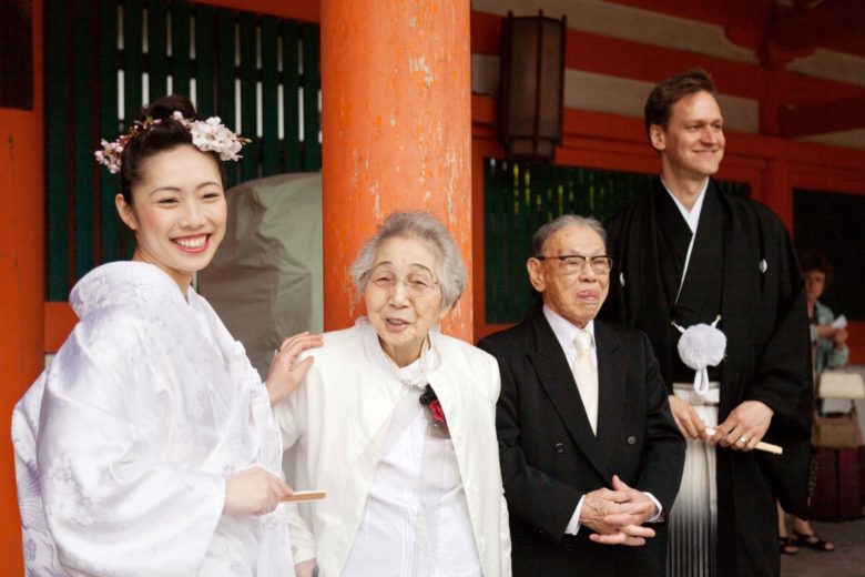 Bride and groom in Japanese wedding outfits, with older relatives