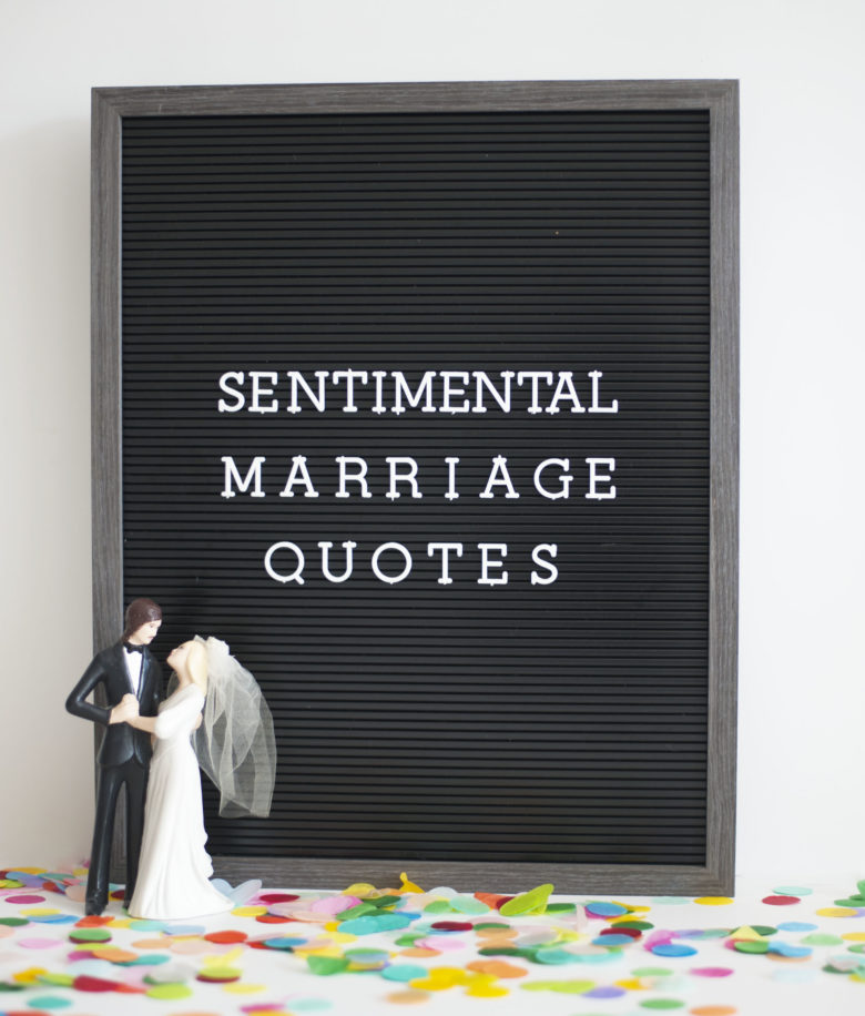 black board on confetti next to bride and groom toy that says "sentimental marriage quotes"