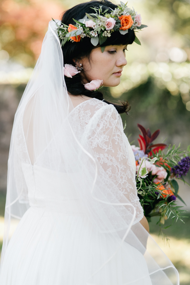 a bride looks elegant with her flower crown and bouquet