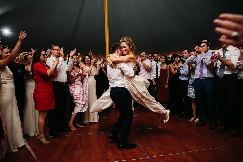 groom spinning bride in the air on the dance floor