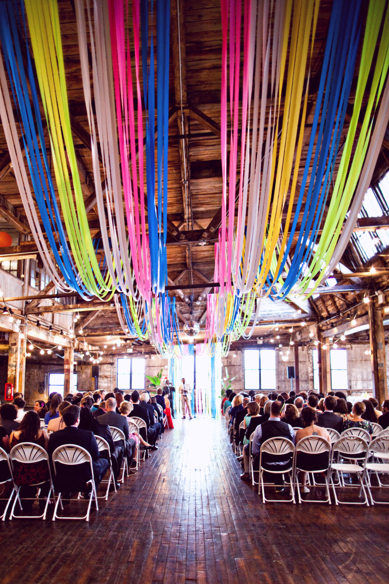 multi colored flagging tape installation at an indoor wedding ceremony