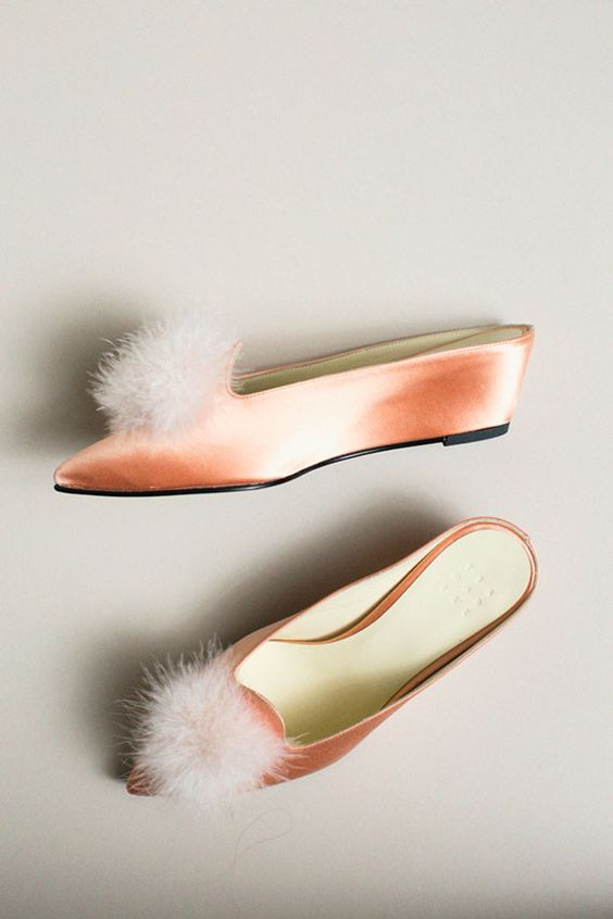 peach shoes with a furry tuft on the top