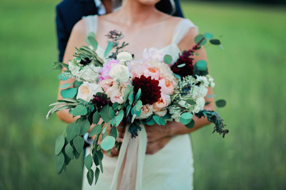 bride holding bouquet of heirloom roses and eucalyptus