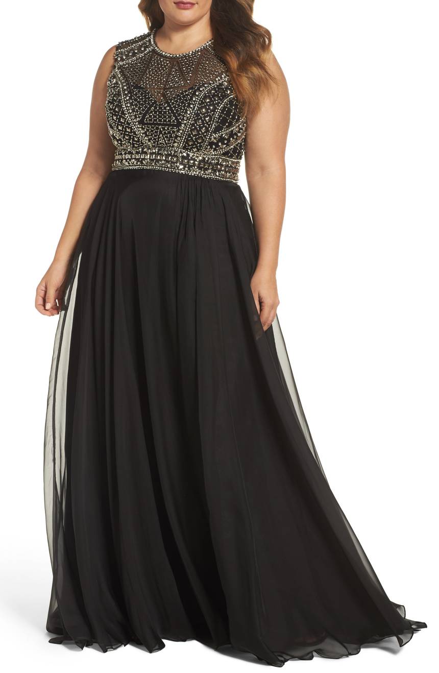 Plus size brunette woman wearing a black and silver embellished gown