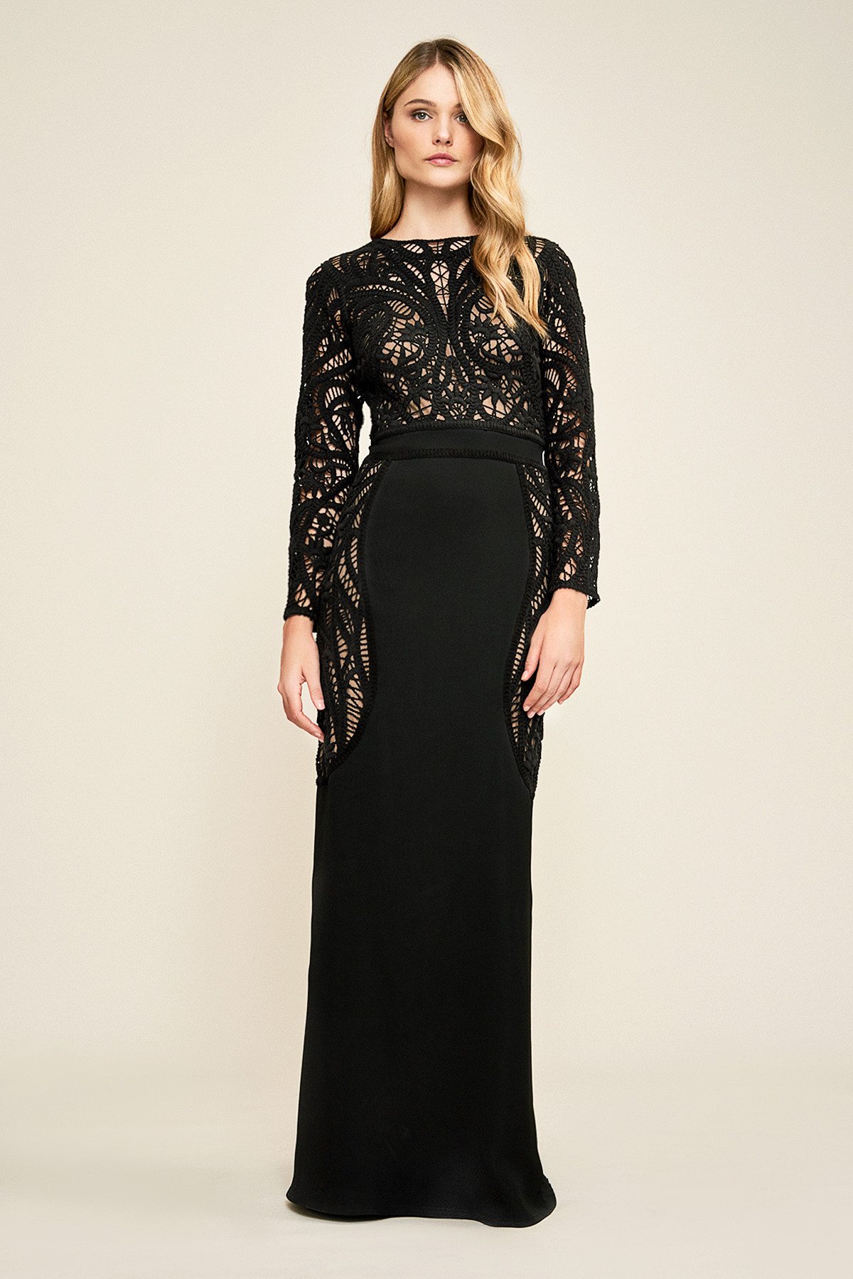 Blonde model posing in intricate lace black fitted full-length sheath Tadashi Shoji gown