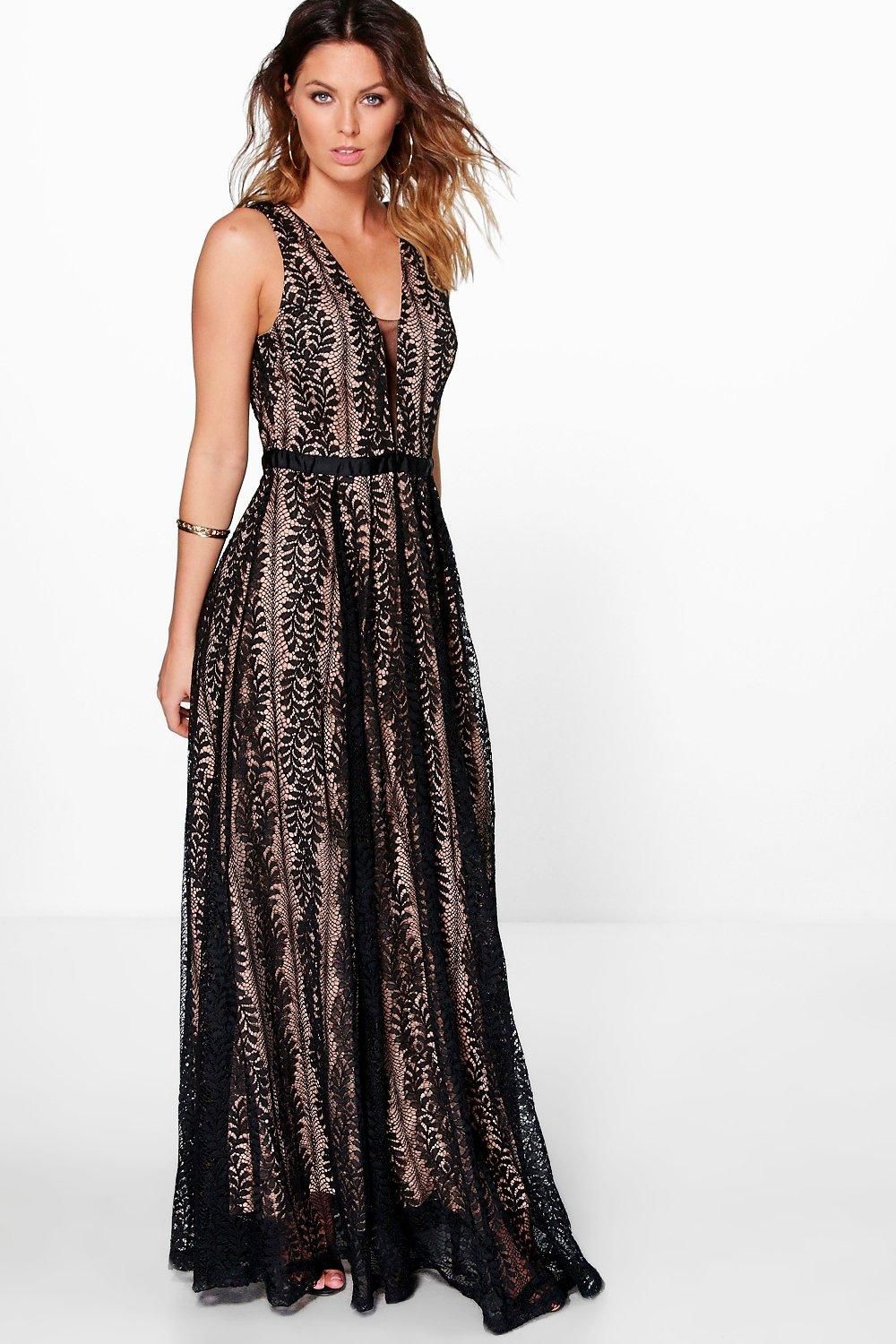 Tousled hair blonde model in lace overlay black maxi dress with plunge neckline