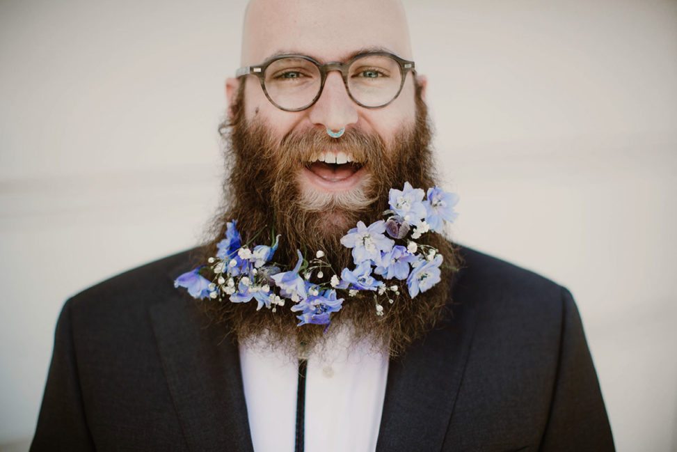 bald man with nose ring and beard with flowers