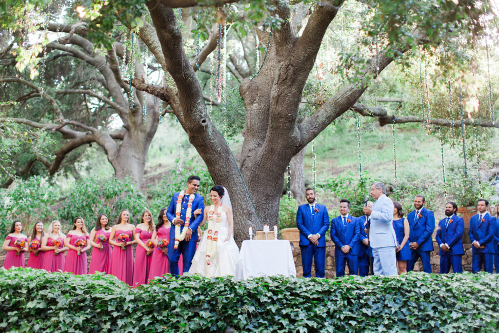 A bride and groom get married underneath a giant tree 