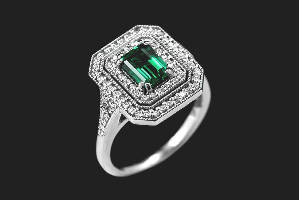 vintage inspired cocktail diamond engagement ring with ethical emerald center stone