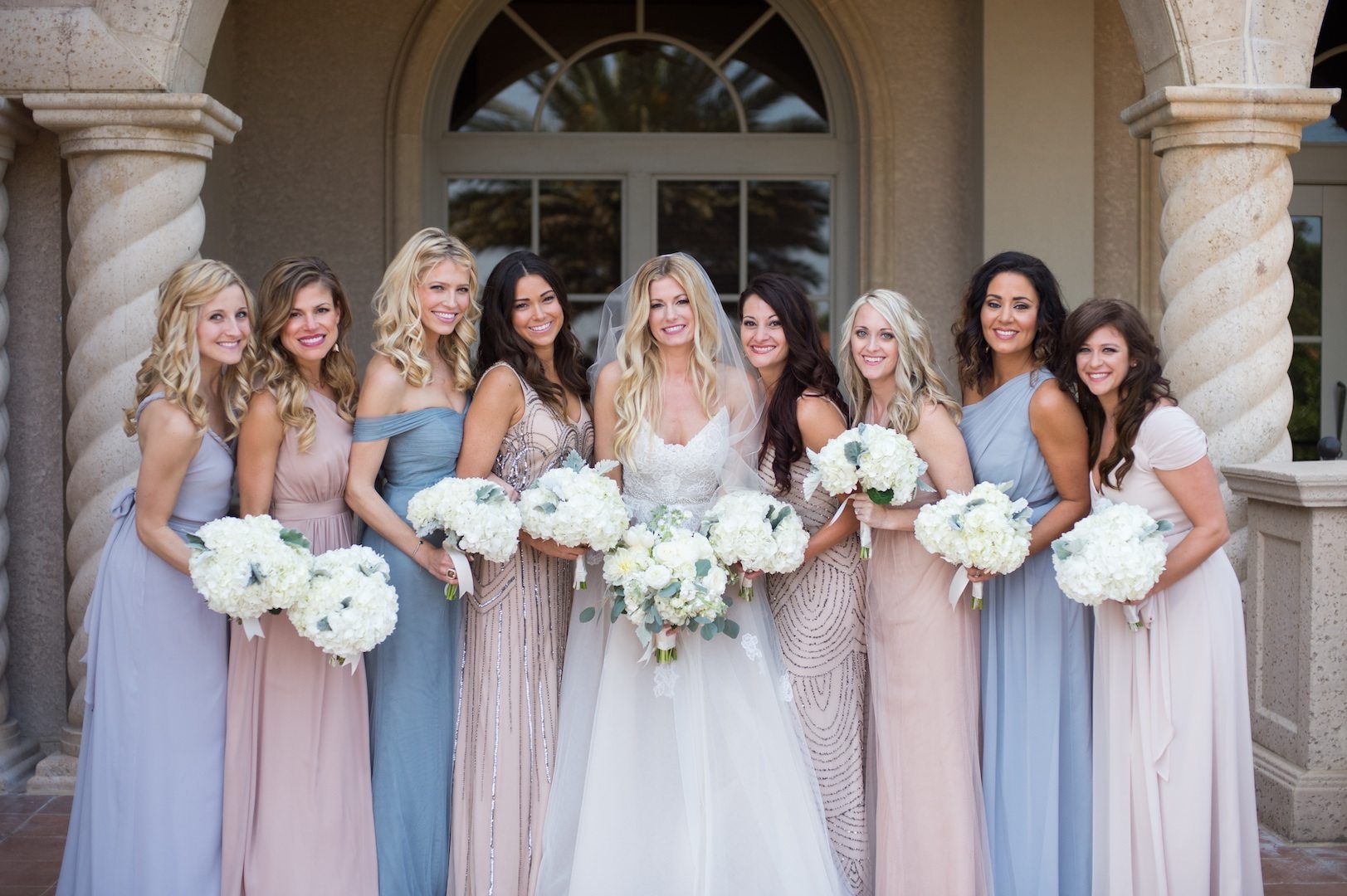 bridesmaids wearing mismatched bridesmaid dresses in cornflower blue and blush and sequins
