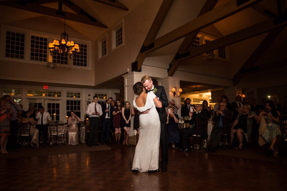 a bride and groom dance a slow dance during their reception