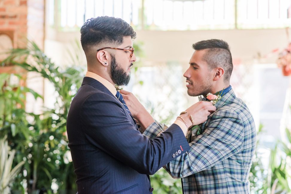 two men adjusting each other's tie