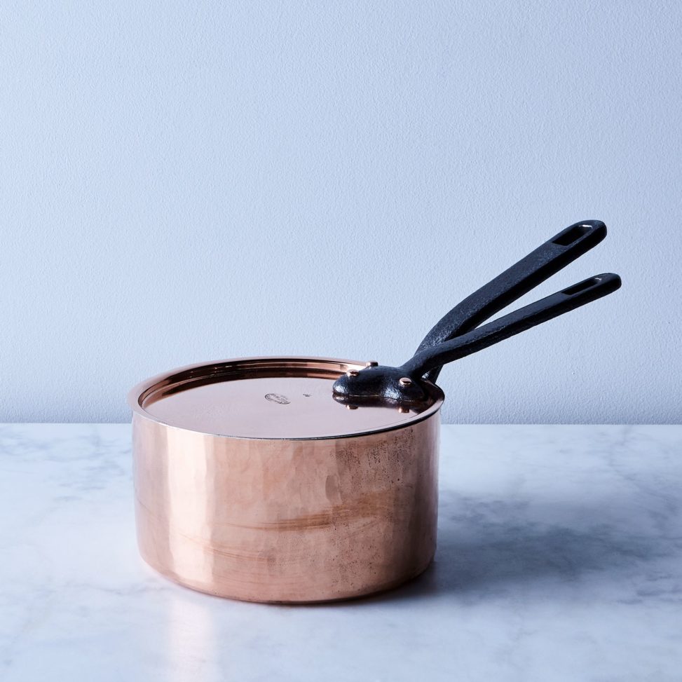 copper pot sitting on marble counter