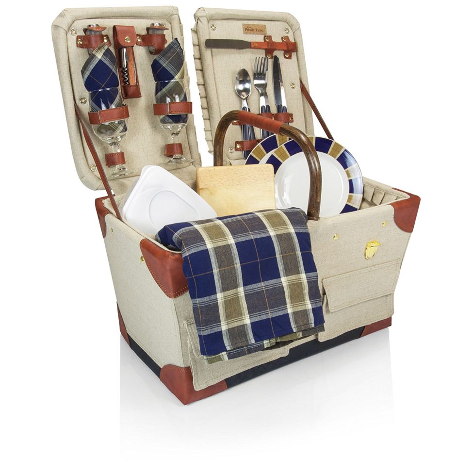 wedding gift ideas - a picnic basket on white filled with plaid towels and dishes