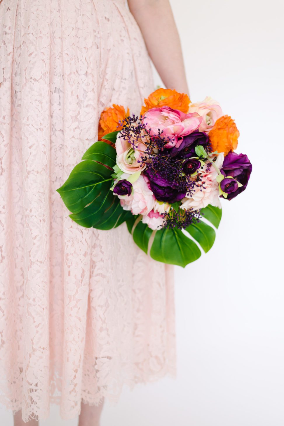 Fake floral bouquet that looks real with silk tropical leaves and silk multicolored flowers