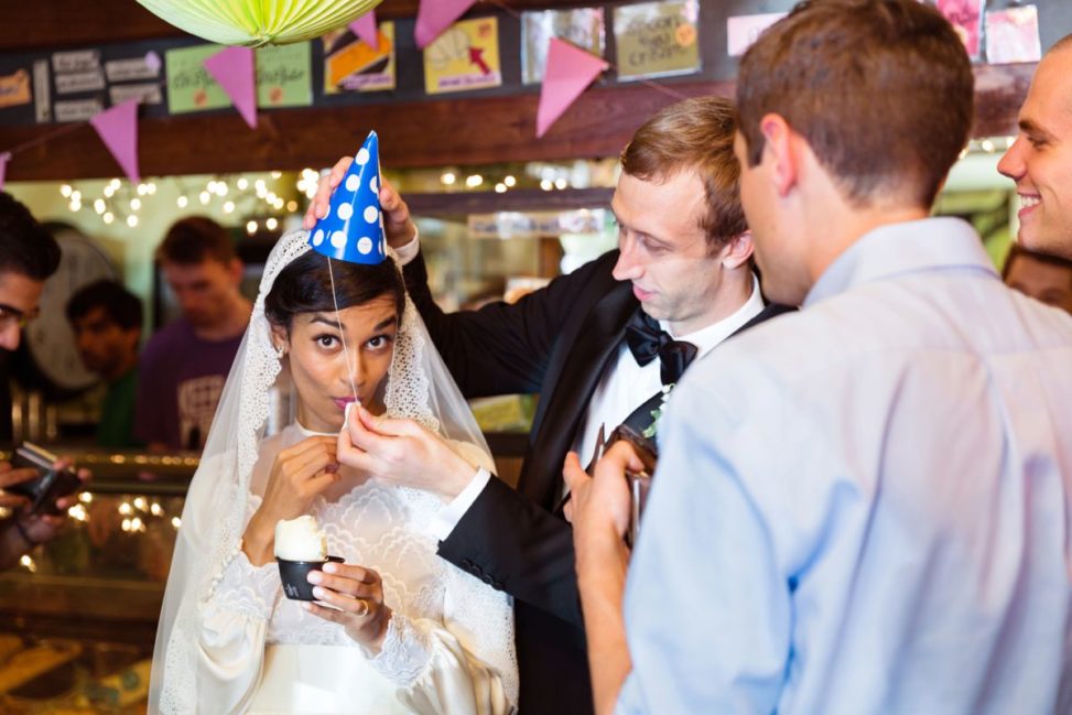 a man puts a party had on a bride