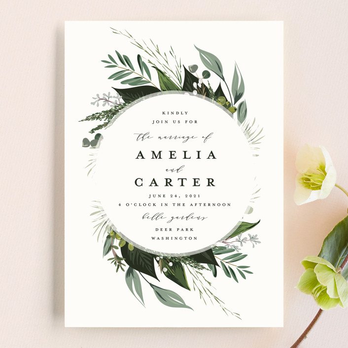 Wedding invitation with florals and green leaf pattern