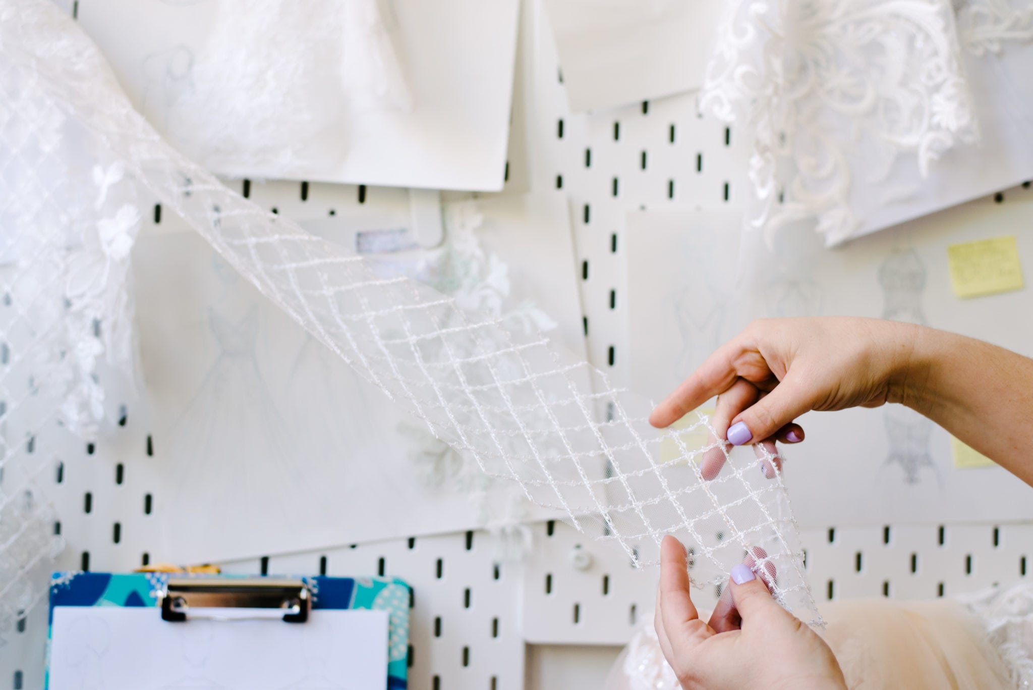 a pair of hands examine fabric