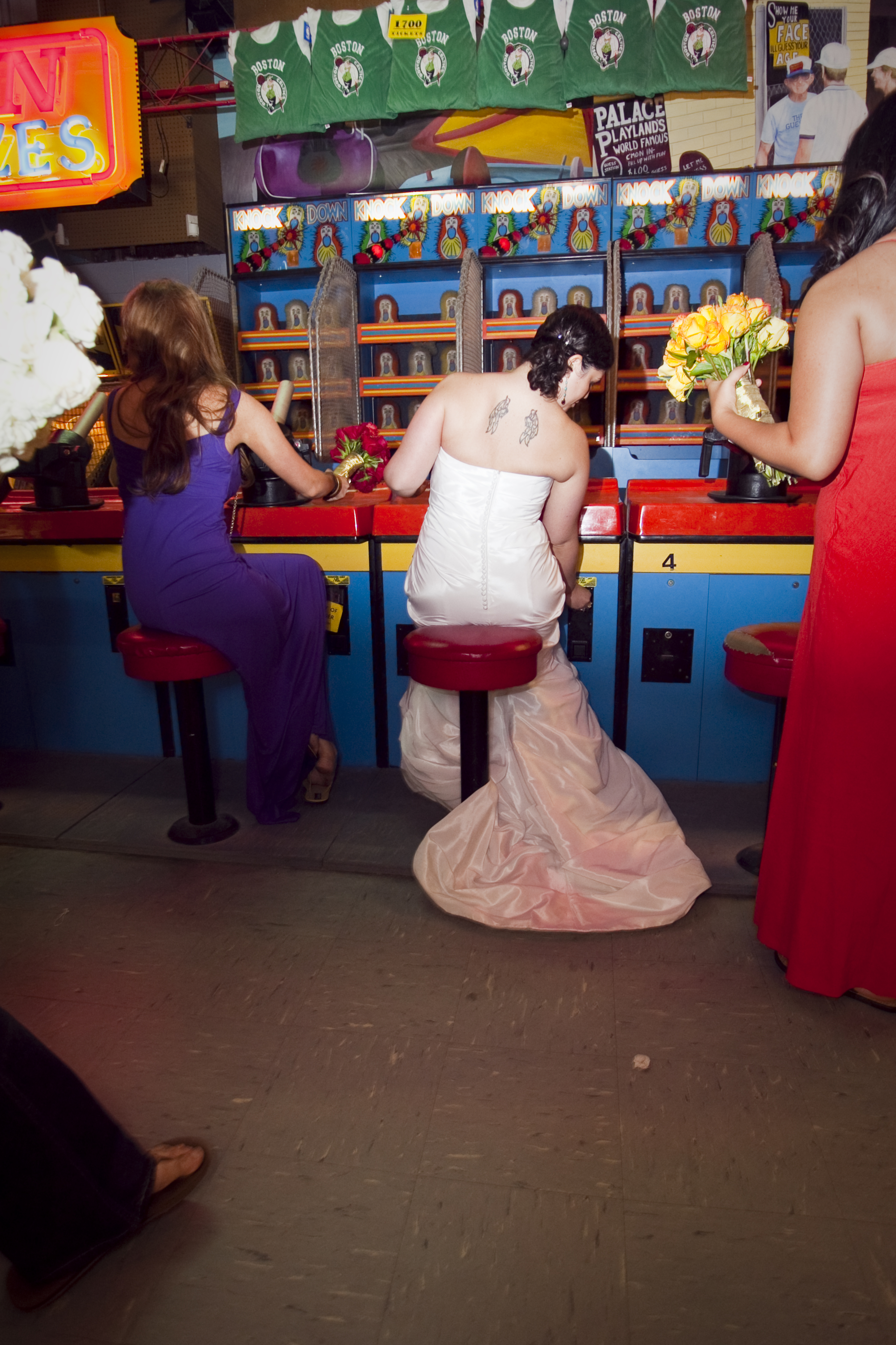 A bride plays midway carnival games