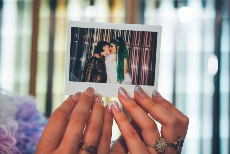 A photo of a pair of hands holding an instant developed photo
